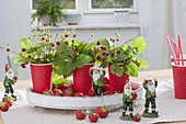Strawberry table decoration in red and white cups