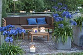 Terrace in the evening light, tub with agapanthus, lanterns