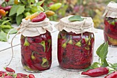 Red hot peppers (Capsicum annuum) pickled sweet and sour in jar