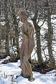 Woman figure made of terracotta in the wintry garden