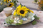 Small decoration with helianthus and green apples