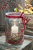 Preserving jars juiced as lantern, interspace with roses