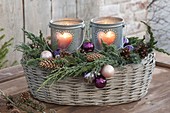 Heart lanterns in basket with branches of Juniperus