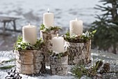 White candles with moss on birch stems