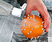 Oranges as decoration, glitter on the oranges with liquid glue
