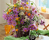 Autumn bouquet with autumnal branches, ornamental gourds, physalis, grasses