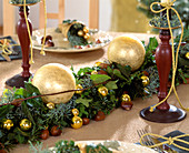 Table decoration with garland of branches and balls
