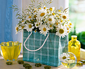 Bag with daisies and grasses