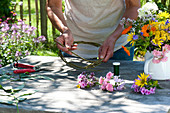 Tying colorful summer flowers wreath