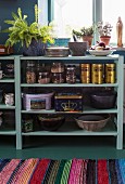 Vintage-style cans and jars on open-fronted kitchen shelves