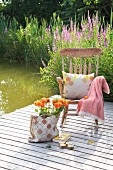 Dahlias in bag next to rocking chair on wooden deck