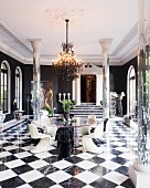 Mirrored pillars, grand doorway, round glass table and classic designer pieces
