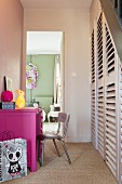 Hot pink desk and under-stair cupboard in hall