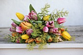 Luxuriant bouquet of tulips and delicate touch-me-not