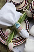 Linen napkin with embroidered napkin ring and tulips on plate