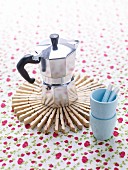 Espresso pot on trivet made from clothes pegs