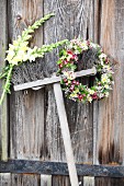 Flower wreath and two snapdragons hung from broom