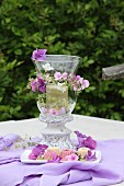 Romantic candle lantern decorated with purple hydrangea and phlox flowers