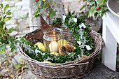 Candle lantern, box arrangement, quinces and sweet chestnuts in basket