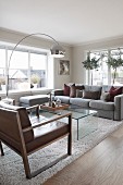 Arc lamp and grey couch in elegant lounge area
