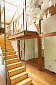 Modern wooden staircase in renovated period building with half-timbered structure