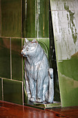Green tiled stove with cat ornament