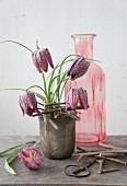 Flower stand hand-made from twigs on pot and snake's head fritillaries