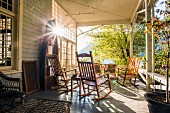 Wooden rocking chairs on sunny veranda