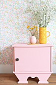 Vases on top of old bedside cabinet painted pink
