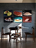 Pictures of culinary motifs above table and retro chairs