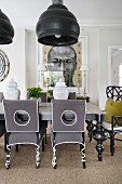 Upholstered chairs and oversized lamps in opulent dining room
