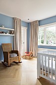 Rocking chair and rocking horse in pale blue nursery