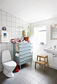 Old chest of drawers in simple bathroom