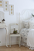 Ornate metal bed in white, vintage-style bedroom