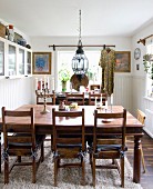 Rustic wooden table in dining room with white wainscoting