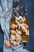 Eggs and crumpled paper in vintage cardboard box