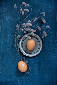 Eggs, pewter plate and dried twigs