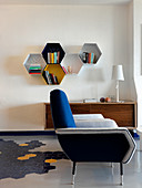 Wall-mounted shelves made from honeycomb elements in living room