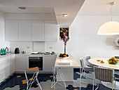 Open-plan kitchen and dining room with blue hexagonal floor tiles