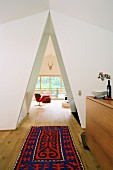 Brightly patterned rug in front of triangular open doorway