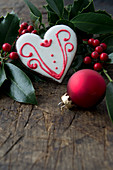 Heart-shaped iced biscuit, holly and bauble