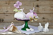 Card gift boxes and paper butterflies on cake stand