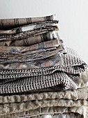 Sand-coloured and grey bed linen and blankets