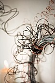 Detail of wire wreath made from wrapped silver and black cable