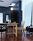 Wooden table and various chairs in elegant interior