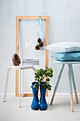 Stool, picture frame with Christmas decorations and Wellington boots