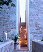 Narrow external staircase illuminated by candle lanterns