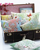 Floral cushion in old suitcase