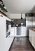 Stainless steel fridge in white fitted kitchen