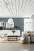 Grey and white living room with white wood-clad ceiling
